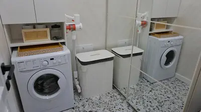 a laundry room with a washing machine and a washer and dryer at Byala Cliff Sea View Suite in Byala