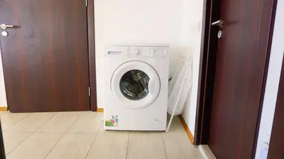 a white washing machine sitting in a room at Byala Cliff Sea View Penthouse in Byala