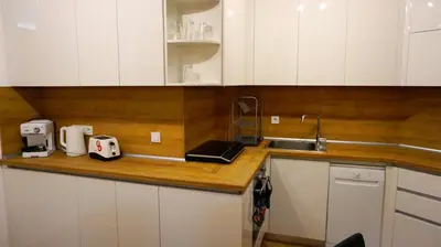 a kitchen with white cabinets and a sink at Апартамент Далия - Apartment Dalia in Varna City