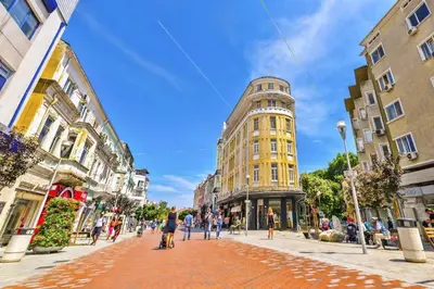 a group of people walking down a city street at Апартамент Далия - Apartment Dalia in Varna City