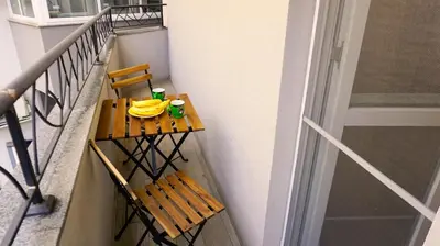 a balcony with a table and two chairs on a balcony at Апартамент Далия - Apartment Dalia in Varna City