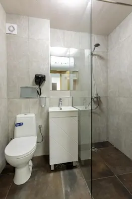 a bathroom with a toilet and a sink and a shower at Стаи за гости ПИРОТСКА 39 in Burgas City