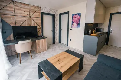 a living room with a couch and a table at хотел ADDRESS in Ravda