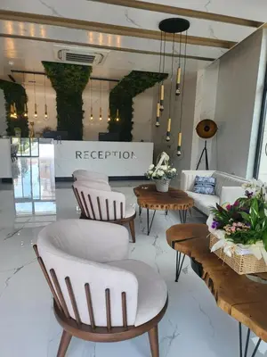 a room with chairs and tables in a store at хотел ADDRESS in Ravda