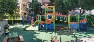 a playground with a slide in a park at Apartmány Rose Residence Nesebar in Sunny Beach
