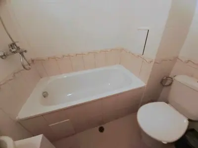 a bathroom with a white tub and a toilet at Apartmány Rose Residence Nesebar in Sunny Beach