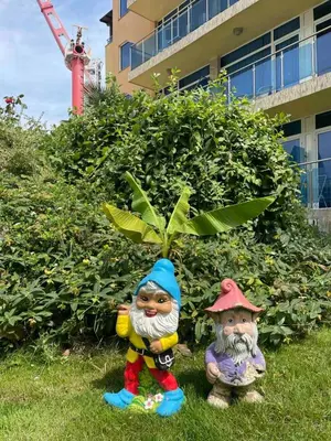 two statues sitting in the grass next to a plant at Apart hotel Gallery A in Sunny Beach