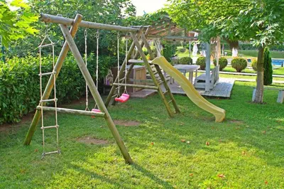 a playground with a slide in a yard at Studio Fresh in Sozopol