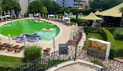 a swimming pool with a slide in a park at ROYAL BEACH & APARTAMENT in Sunny Beach