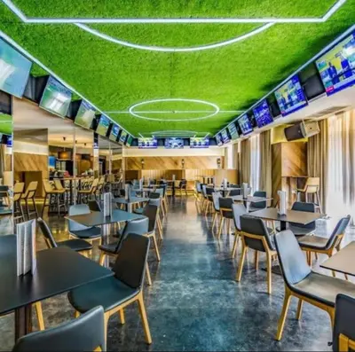 a dining room with tables and chairs and green ceiling at ROYAL BEACH & APARTAMENT in Sunny Beach