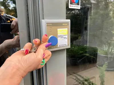 a person is unlocking a door with their hand at Joy Apartment Sunny Beach in Sunny Beach