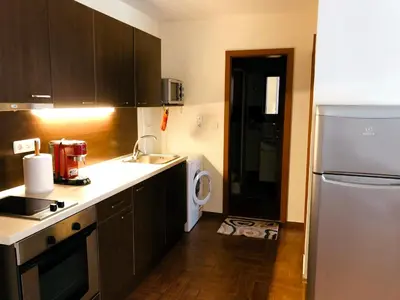 a kitchen with a sink and a refrigerator at Beautiful apartment right by the sea, Sveti Vlas in Sveti Vlas