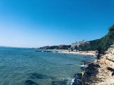 a view of a beach with people in the water at Beautiful apartment right by the sea, Sveti Vlas in Sveti Vlas