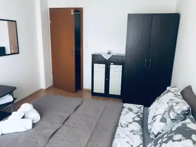 a bedroom with a bed with a teddy bear on it at Beautiful apartment right by the sea, Sveti Vlas in Sveti Vlas