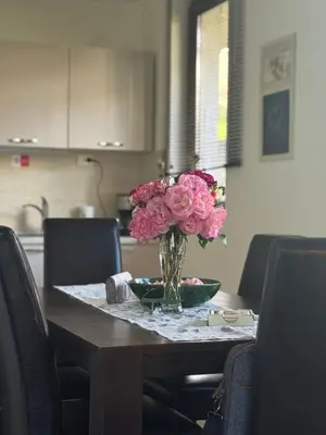 a vase of pink flowers sitting on a table at Villa Rada, Bay View Villas in Kosharitsa