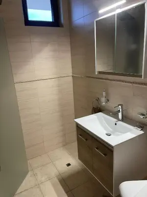 a bathroom with a sink and a mirror at Villa Rada, Bay View Villas in Kosharitsa