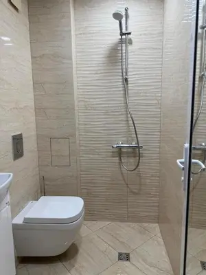 a bathroom with a shower with a toilet and a glass shower at Apart hotel Gallery Studio in Sunny Beach
