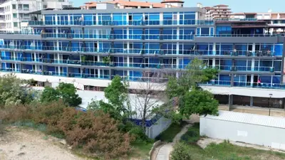 a large apartment building with blue windows at Apart hotel Gallery Studio in Sunny Beach