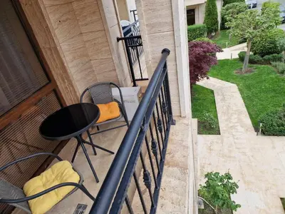 a balcony with a table and chairs on a porch at Апарткомплекс Амара Слънчев Бряг Студио 13 in Sunny Beach