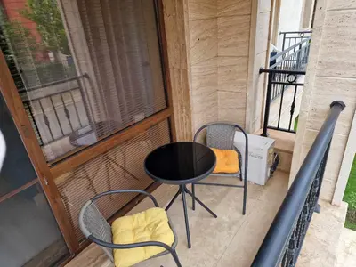 a balcony with a table and chairs on a balcony at Апарткомплекс Амара Слънчев Бряг Студио 13 in Sunny Beach