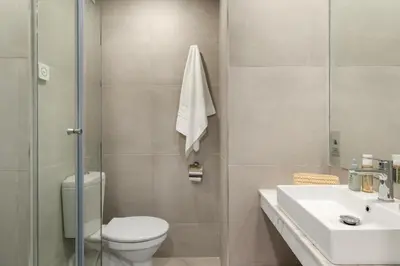 a bathroom with a toilet and a sink at PERLA TUI SUNEO All inclusive in Sunny Beach