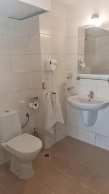 a bathroom with a toilet and a sink at Obzor Beach Resort Beachfront in Obzor