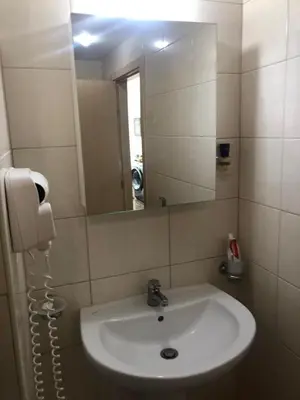 a bathroom with a sink and a mirror at Obzor Beach Resort Beachfront in Obzor