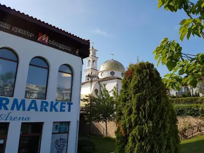 a building with a mosque in the background at Monastery Apartment 14, St. Vlas in Sveti Vlas