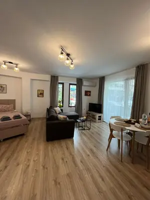 a living room with a couch and a table at Studio Marrone on Bogoridi in Burgas City