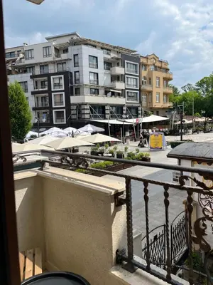 a balcony with a view of a city with buildings at Studio Marrone on Bogoridi in Burgas City