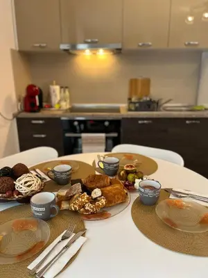 a table with plates of food on it in a kitchen at Studio Marrone on Bogoridi in Burgas City