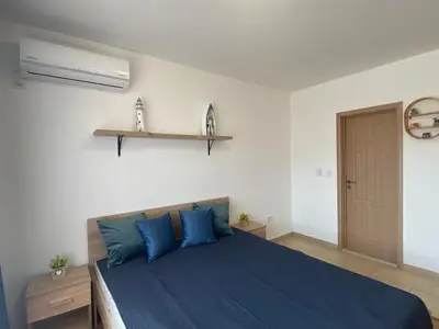 a bedroom with a blue bed with blue pillows at SUMMER BREEZE 110 Cozi Studio in Sunny Beach