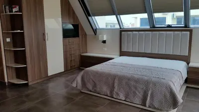 a bedroom with a bed and a large window at Studio Milenium in Pomorie