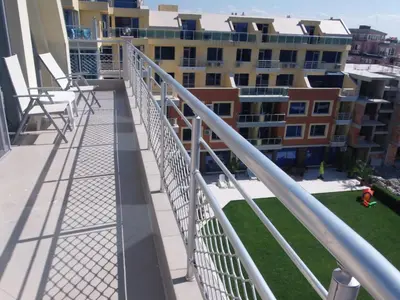 a balcony with a metal railing and a building at Studio Milenium in Pomorie