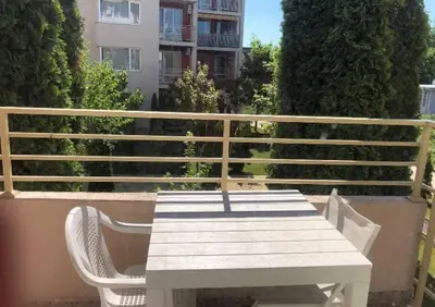 a white picnic table and chair on a balcony at Cosy, Studio Apartment At Nesebar Fort Club in Sunny Beach