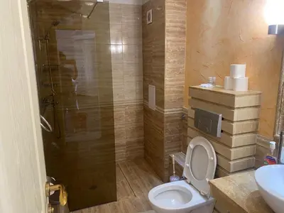 a bathroom with a shower and a toilet and a sink at Penthouse Happy Moments 2 in Sunny Beach