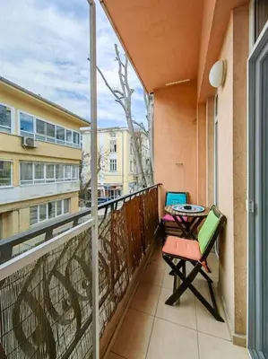 a balcony with a table and chairs on a balcony at Varna Central Ohrid 2bdr Apartment in Varna City