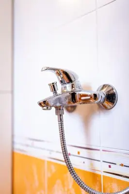a shower head on a wall in a bathroom at Varna Central Ohrid 2bdr Apartment in Varna City