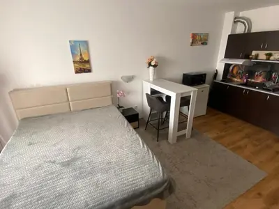 a bedroom with a bed and a desk with a chair at Royal Palm Studio with Seaview in Sveti Vlas