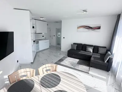 a living room with a couch and a table at Admiral Plaza Apartment , Large swimming pool , 5 min walking to the beach in Sunny Beach