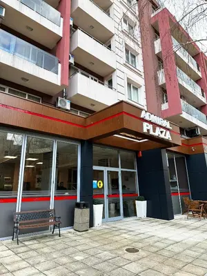 a building with a bench in front of it at Admiral Plaza Apartment , Large swimming pool , 5 min walking to the beach in Sunny Beach