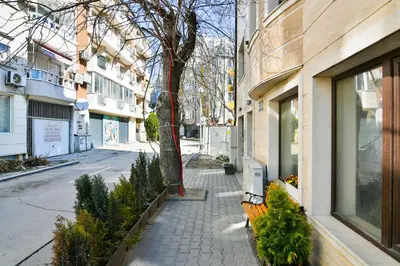 a street with a bench next to a building at Varna beach flat 1 in Varna City