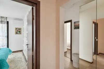 a hallway with a door and a mirror in a room at Varna beach flat 1 in Varna City