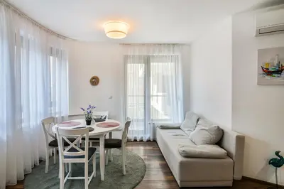 a living room with a table and a couch at Varna beach flat 1 in Varna City