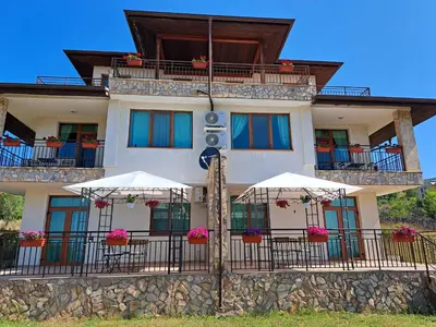 a building with umbrellas in front of it at Buongiorno! Premium in Sveti Vlas