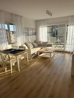 a living room with a couch and a table at Cosy apartments with sea view in complex PANORAMA in Chernomorets