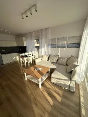 a living room with a couch and a table at Cosy apartments with sea view in complex PANORAMA in Chernomorets