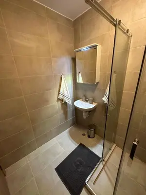 a small bathroom with a sink and a shower at Cosy apartments with sea view in complex PANORAMA in Chernomorets