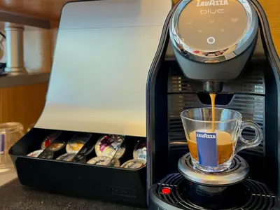 a coffee maker is making a cup of coffee at Premium Apartment Midia Beach in Sunny Beach