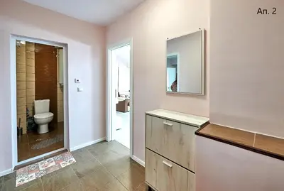 a bathroom with a toilet and a sink and a mirror at Апартаменти Боряна in Pomorie
